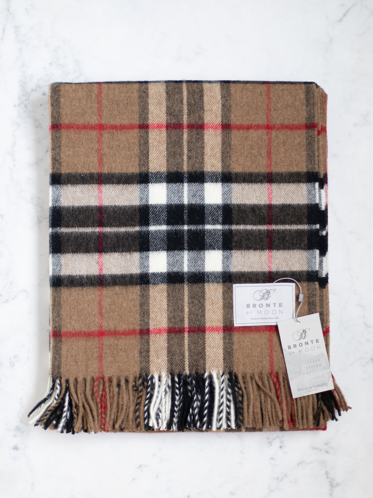 Camel Thompson throw, a deep tan or light brown background with a black, white, and red plaid pattern.