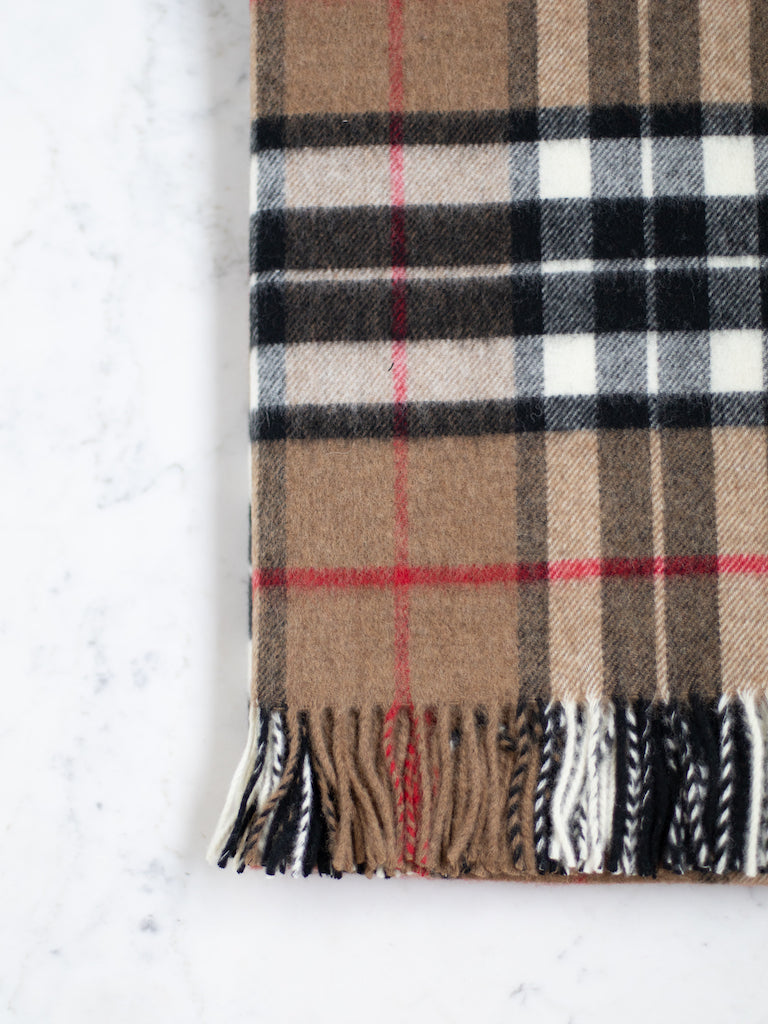 Camel Thompson throw, a deep tan or light brown background with a black, white, and red plaid pattern.