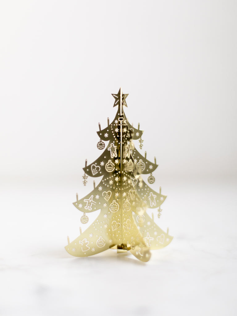 Small Deco Christmas Tree behind a white background.