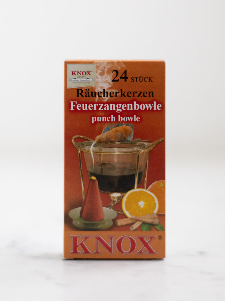 A box cover of an incense scent with pictures of orange and cinnamon in a large pot of water.