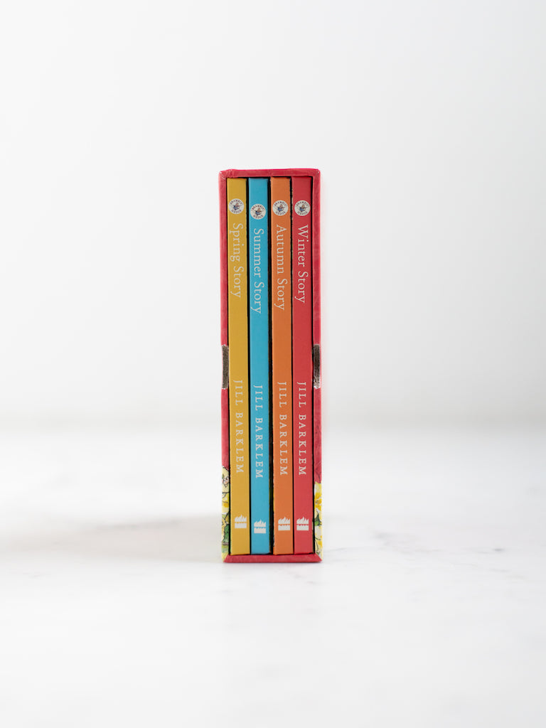 The spines of all the seasons Brambly hedge books, standing next to each other encased in their box packaging.