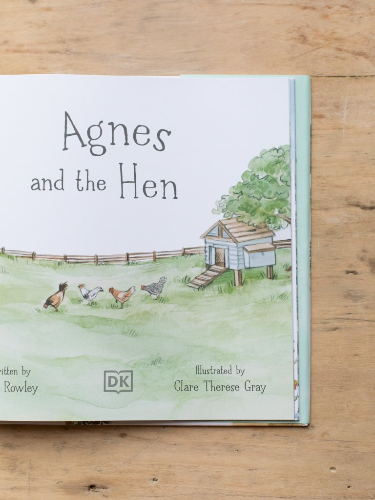Sample of inside title page for “Agnes and the Hen”. The page centers on hens in a farmyard outside their coop.