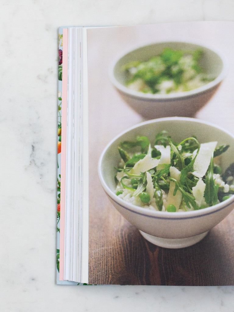 A cookbook opened to a photo of a oatmeal dish. 