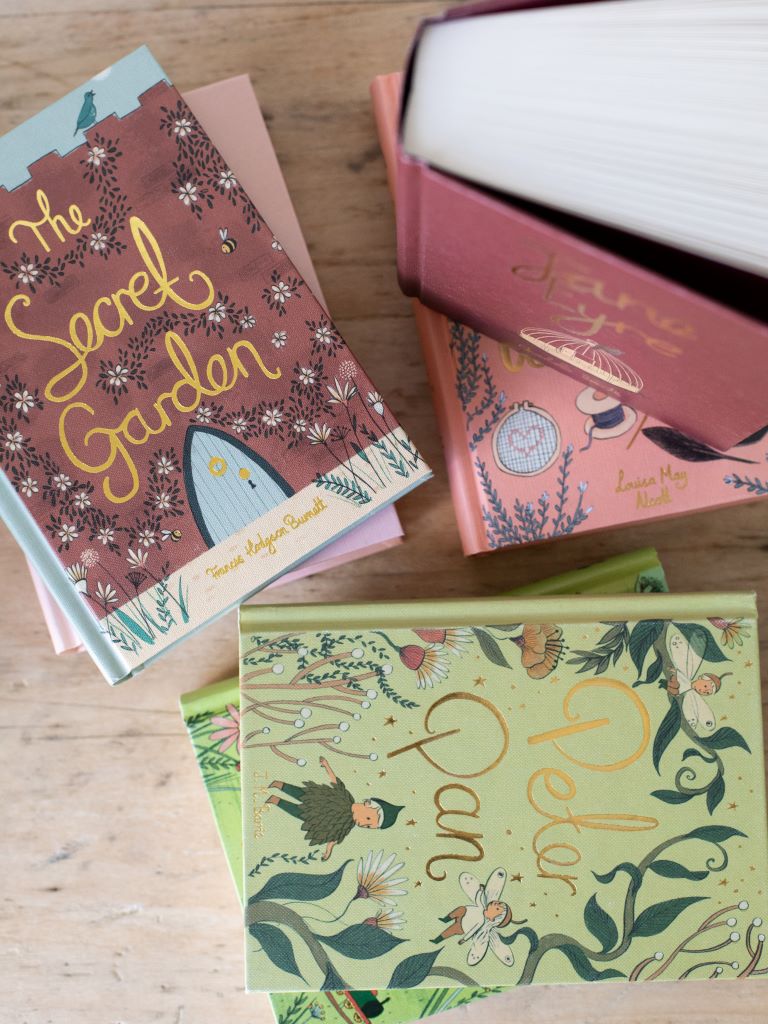 Various hardcover Wordsworth Edition Classic books on a wooden table.