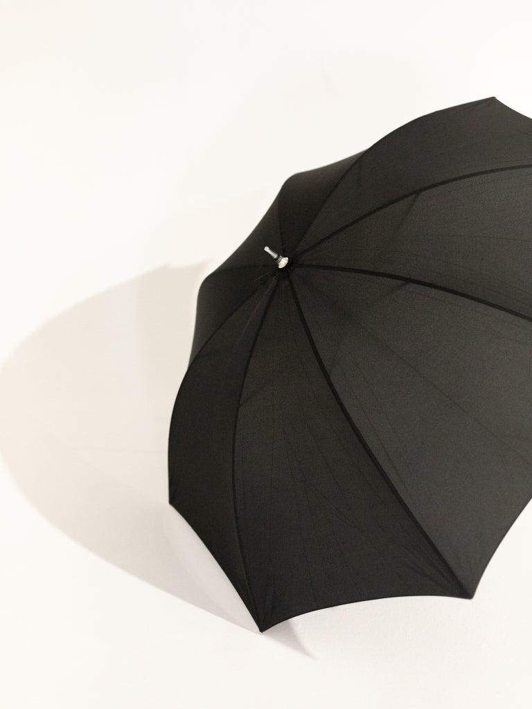 The top of an opened black umbrella.