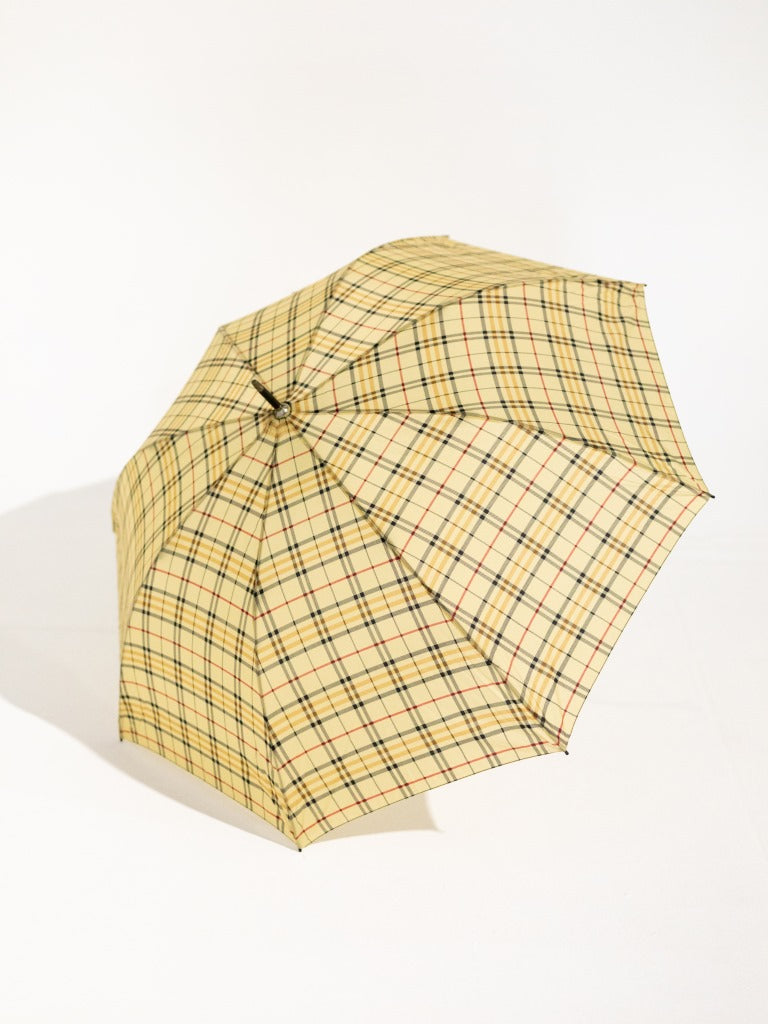 The top of an opened yellow and black checkered umbrella.