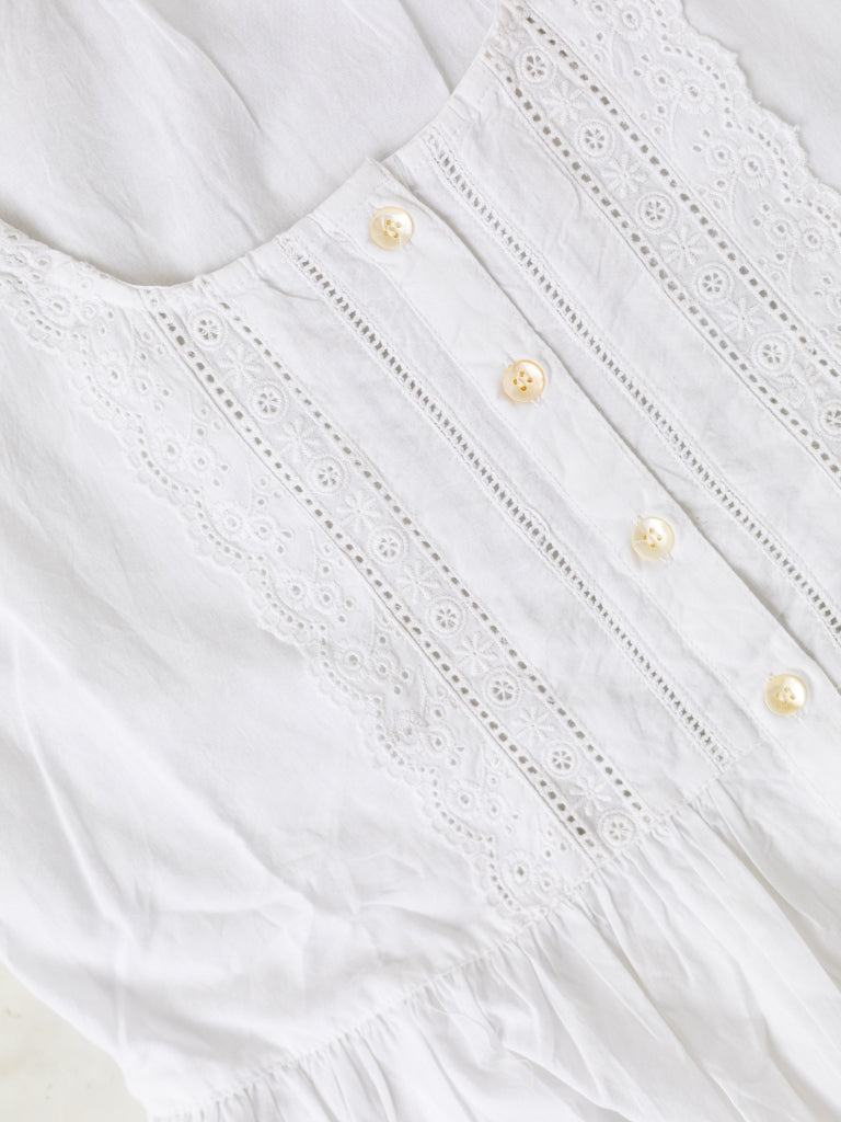 Close up of the Amelia White Nightgown showing daisy lace detailing with creme buttons.