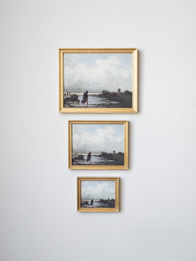 Three framed prints hung on a wall in sequence of largest to smallest.