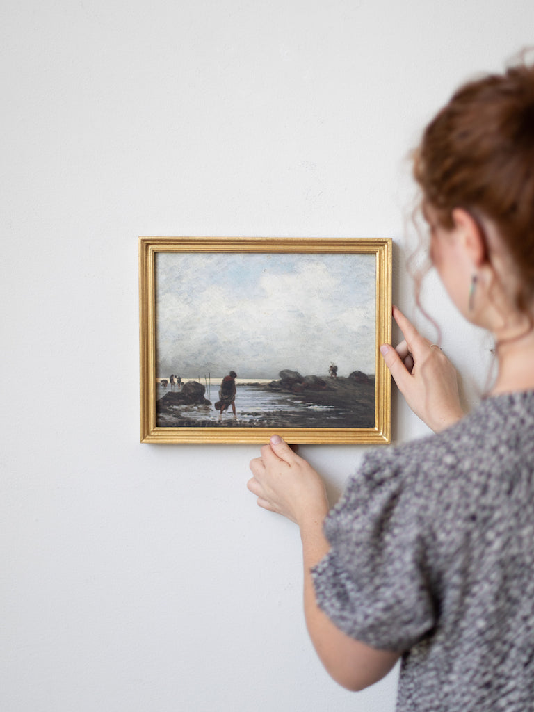 Alternate view of woman handing framed print.