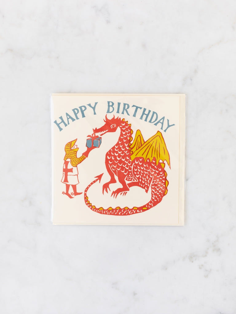 A red and yellow knight giving a wrapped present to a red and yellow dragon happy birthday card.