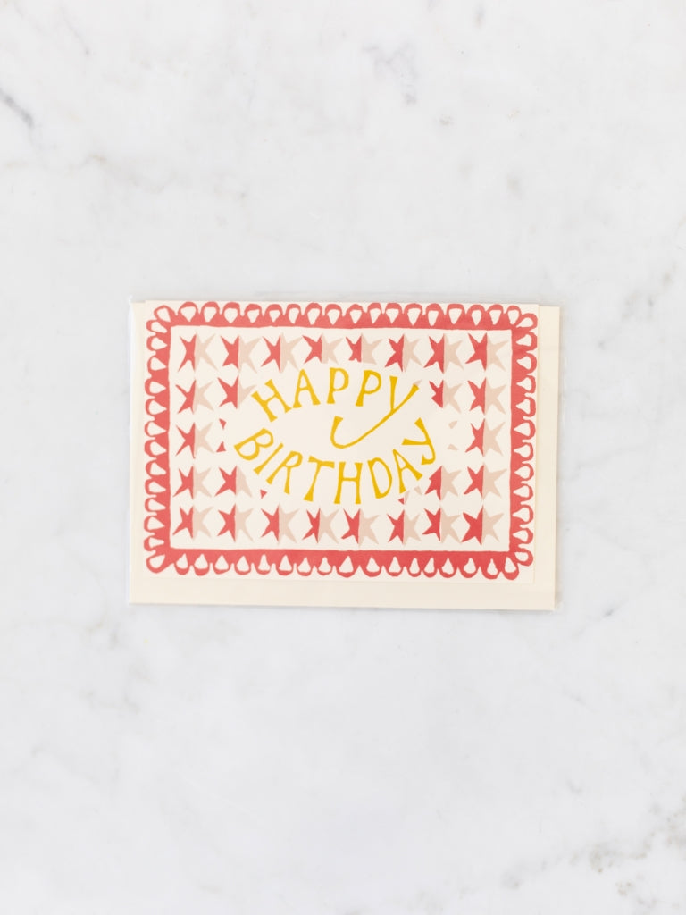 Red stars and yellow lettering happy birthday card.