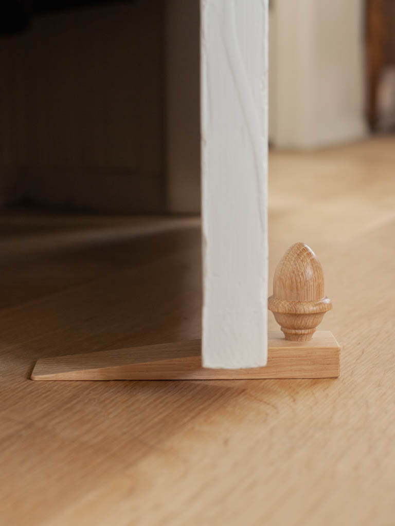 Door stopper with a wood acorn on it for decoration