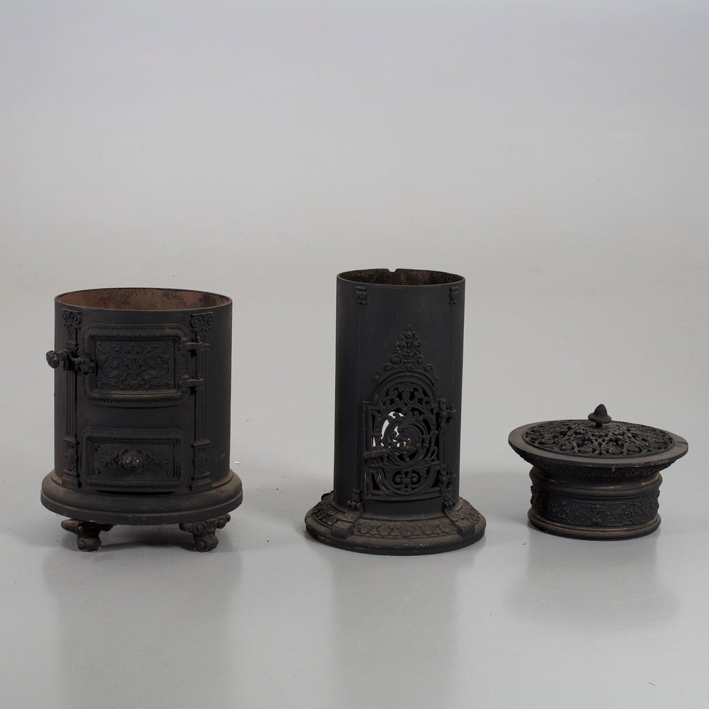Black cast iron stove disassembled into three parts