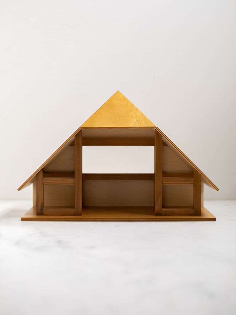 A large wooden and triangle shaped manger, open with space to place character figures.