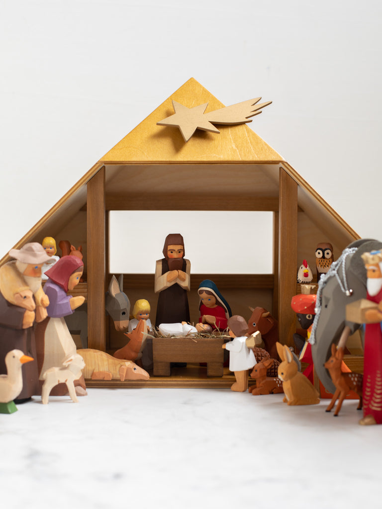 A nativity scene with all included characters under a manger.