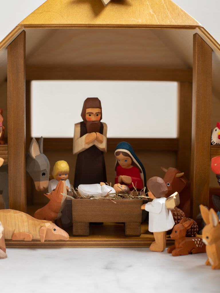 A focus on Mary, Joseph, and Jesus in the manger, includes visuals of other surrounding characters.