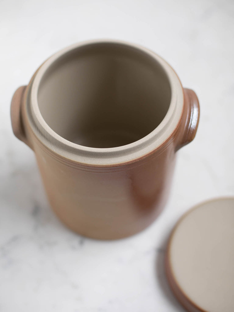 Brown condiment jar opened up to show the inside. 