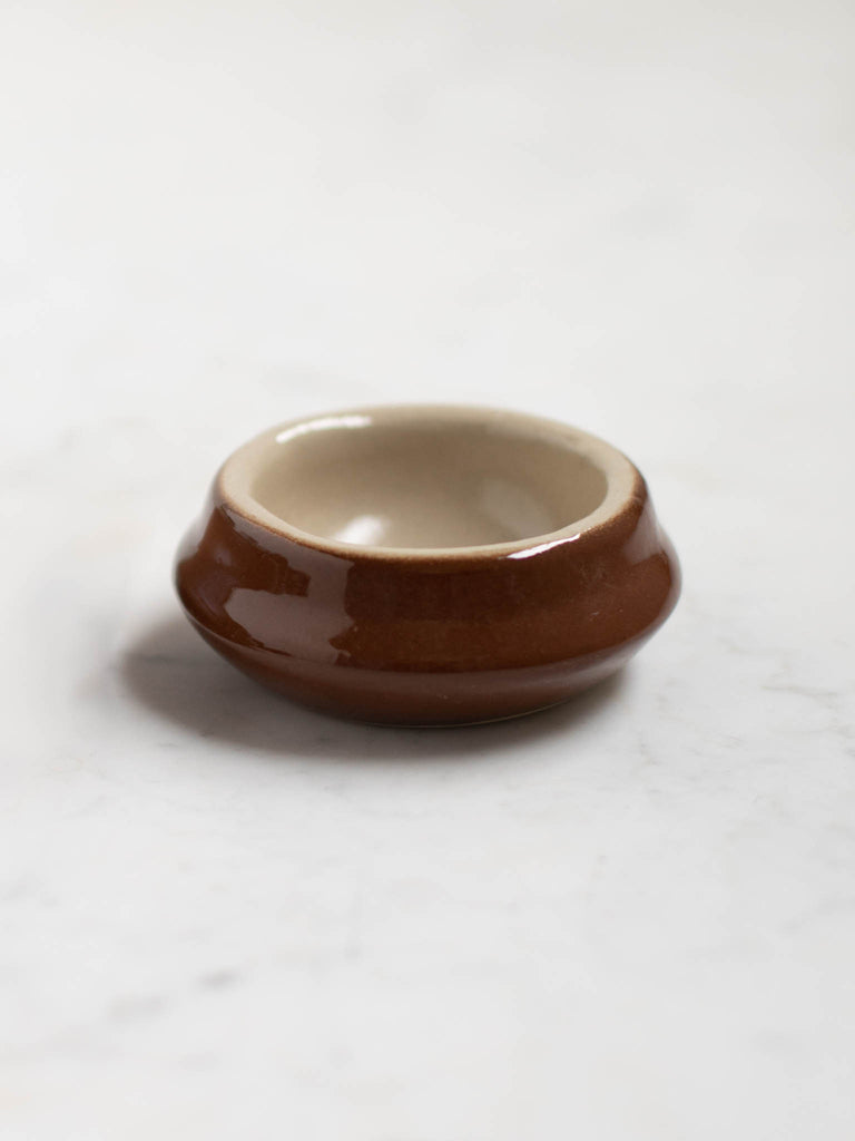 Dark brown small wide dish. 