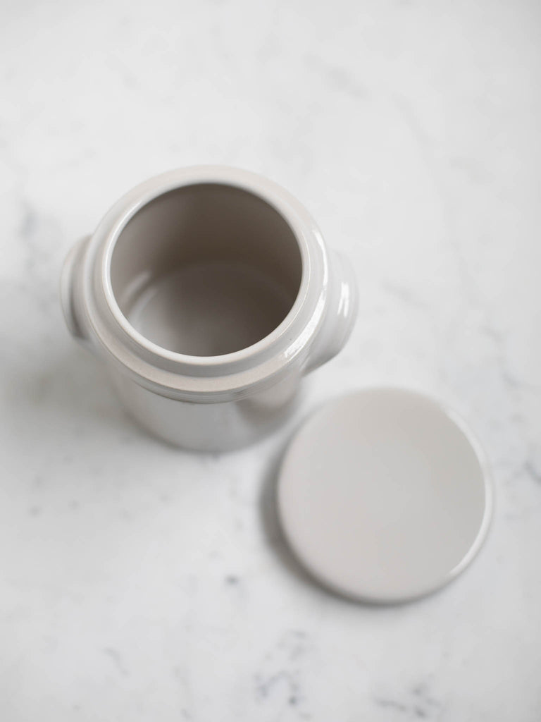 White condiment jar with the lid taken off showing the interior. 