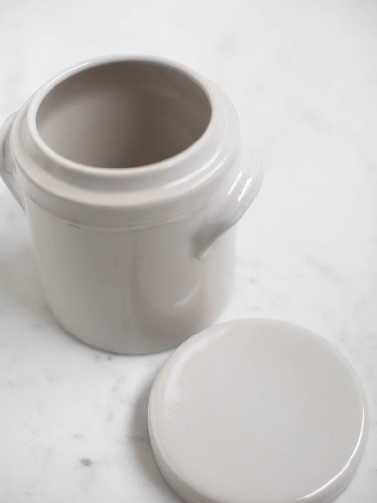 White condiment jar with the lid taken off showing the interior.
