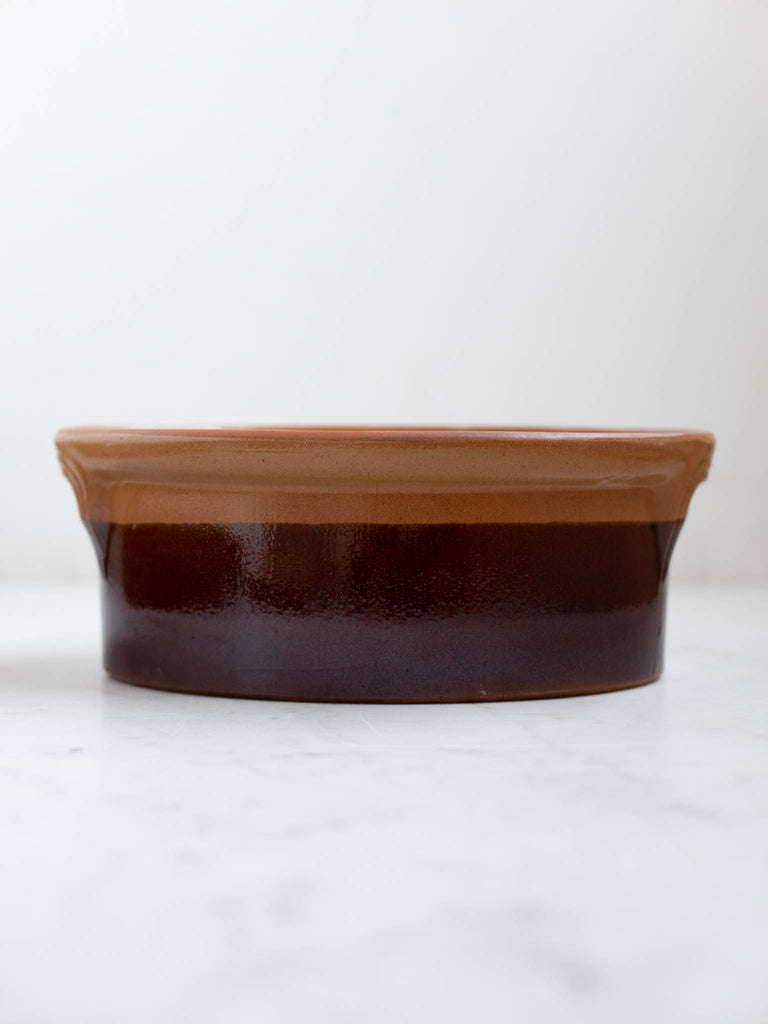 A light and dark brown casserole dish. 