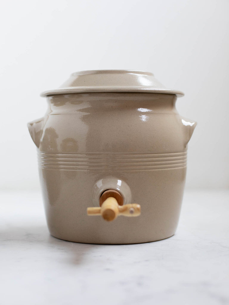 Short white water jug with built in handles. 