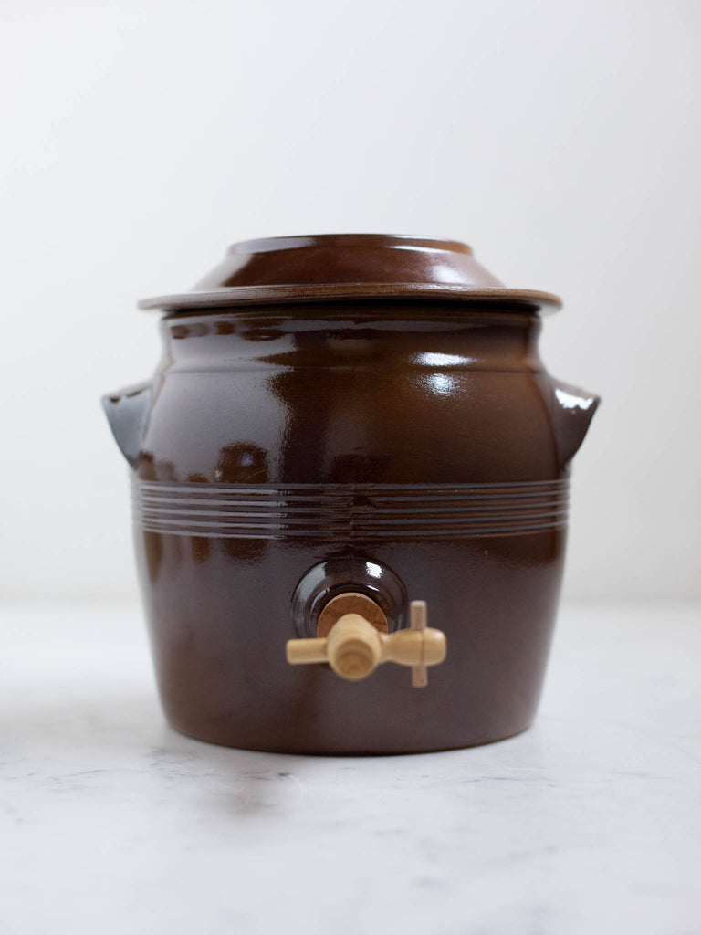 Short dark brown water jug with built in handles. 