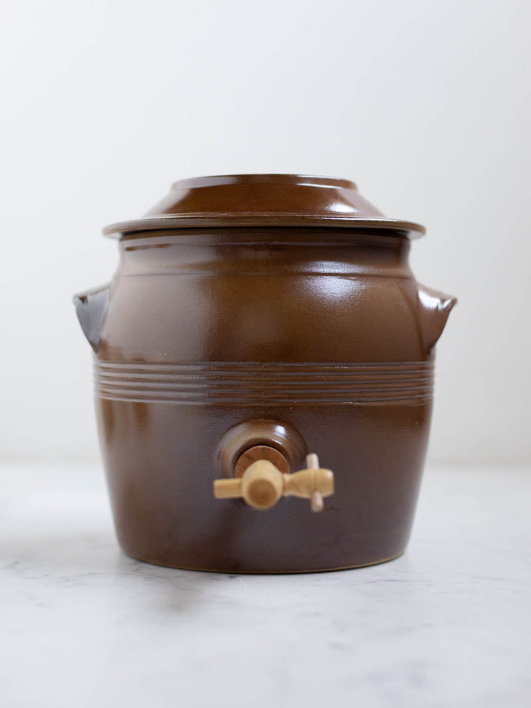 Short dark brown water jug with built in handles. 