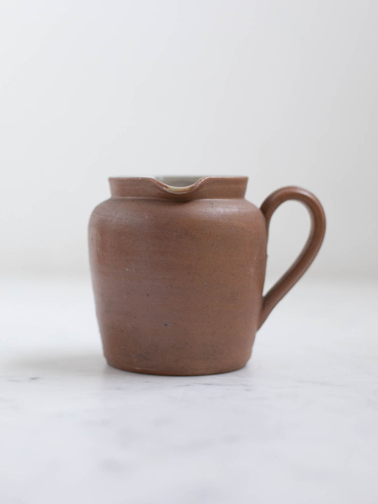 Brown sauce pot with a handle. 