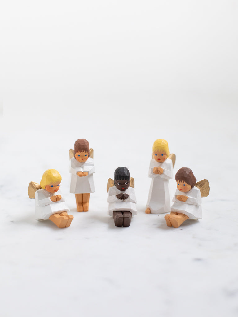 Five small angel wooden figurines in varying positions and characteristics.