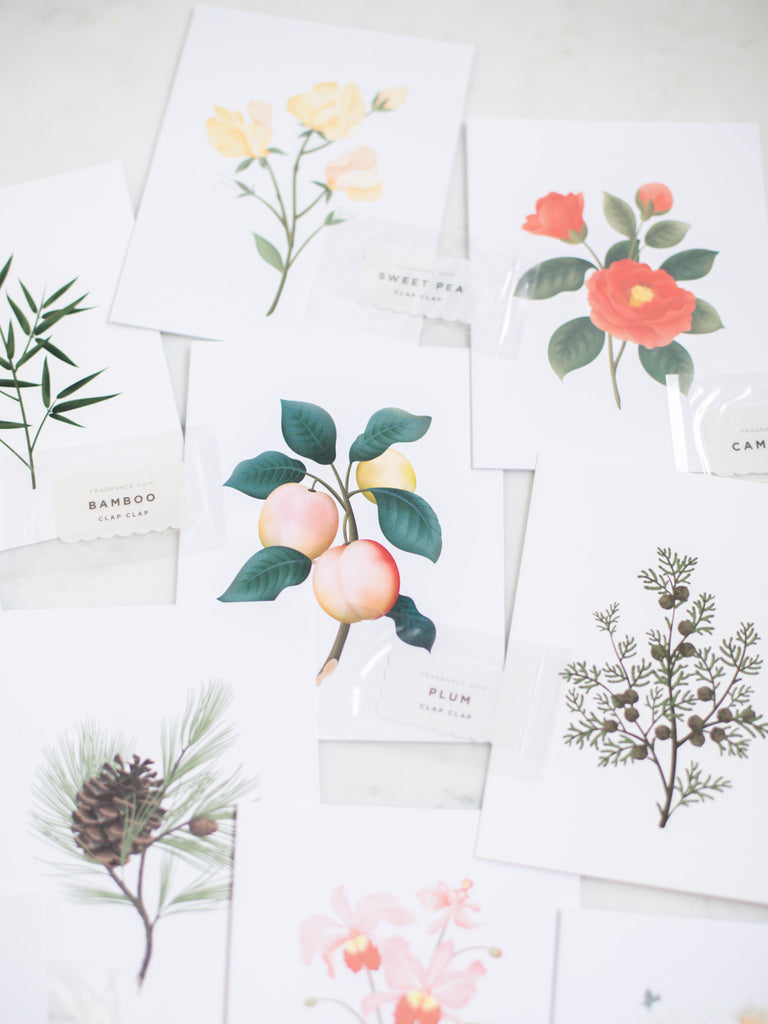 Stack of botanical scented greeting cards including plum.
