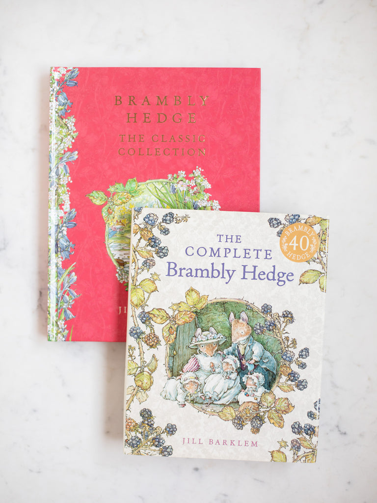 Brambly Hedge the Classic Collection and The Complete Brambly Hedge books laid out on top of one another on a white counter.
