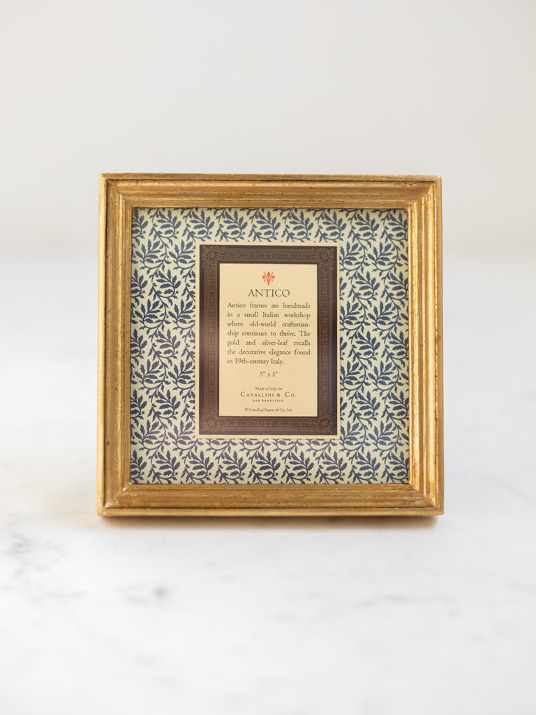 Vintage style gold frames, with a dark blue patterned paper held in the frame, with a description of where the frames are made.