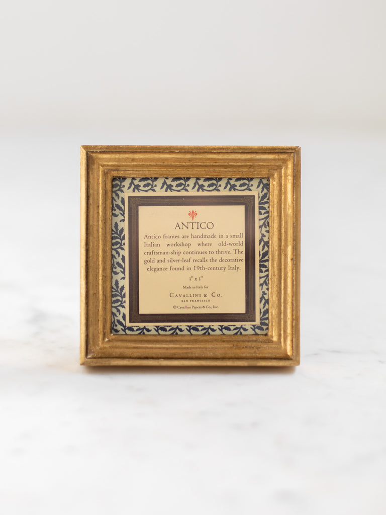 Vintage style gold frames, with a dark blue patterned paper held in the frame, with a description of where the frames are made.