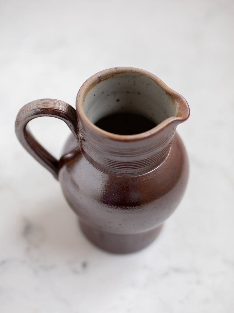 Dark brown pitcher from the top showing speckled interior. 