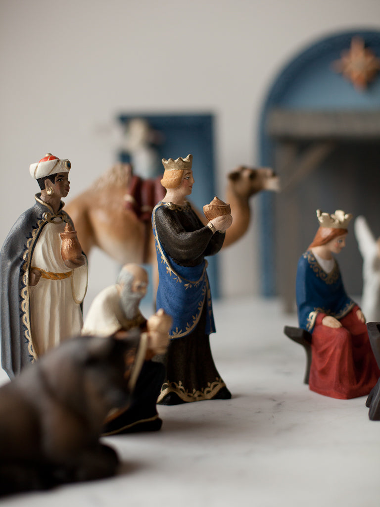 The three kings figurines in various bowing positions.