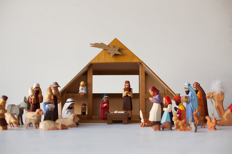A nativity scene with all included characters under a manger.