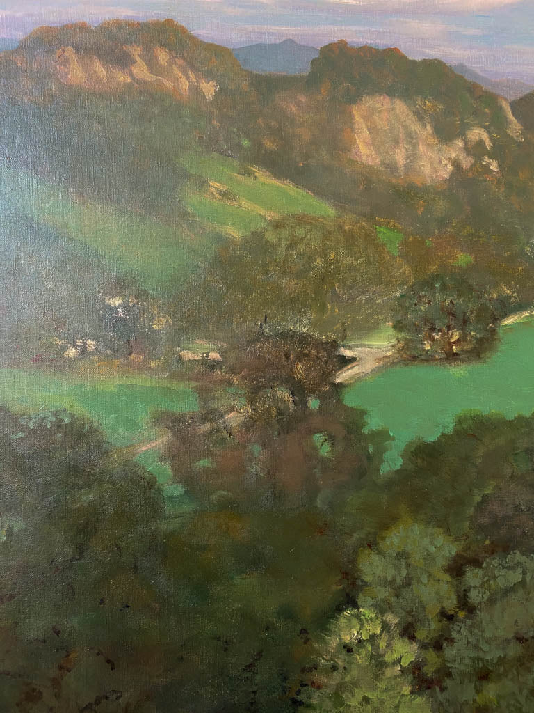 A close up shot of the brushwork on the trees and mountains.