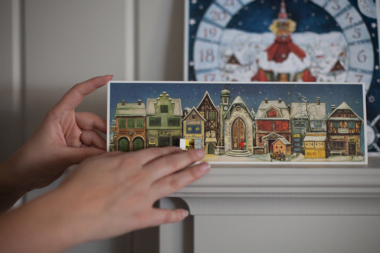 Mini paper stand up showing Christmas village with opening doors and windows. Used as Christmas advent calendar. 