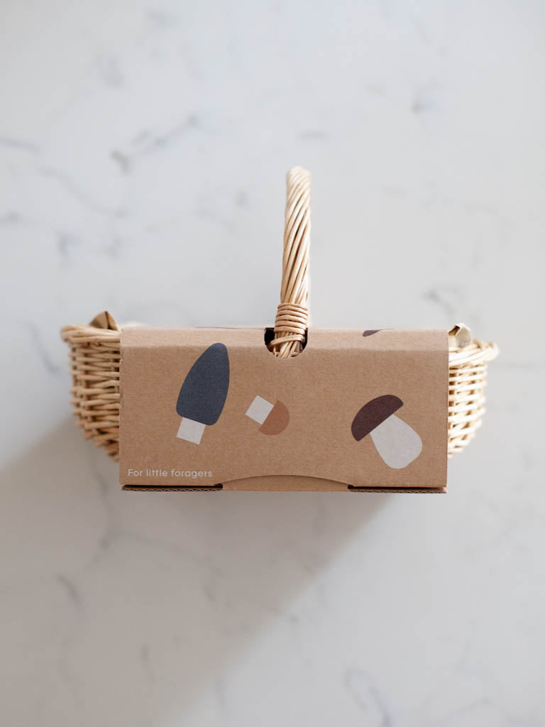 The oval basket turned on its side in its cardboard packaging. 