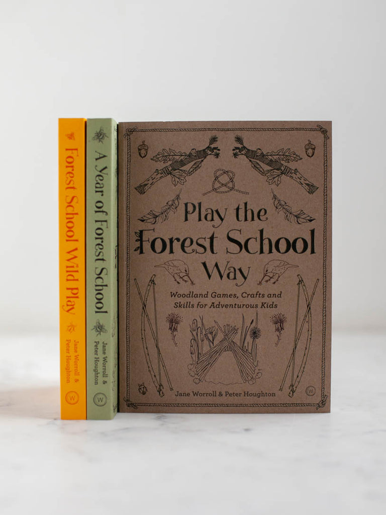 Two books stacked beside a book that is titled “Play the Forest School Way” with woodsy patterns on it’s cover. 