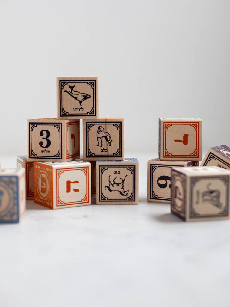 Some blocks decorated with letters, numbers, and animals on their sides. 