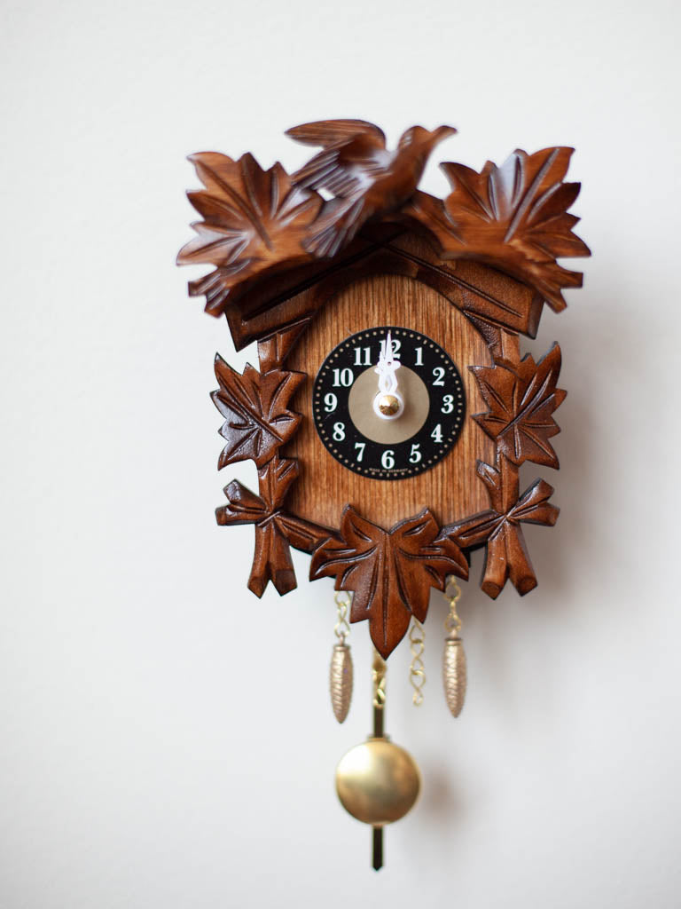 Traditional Black Forest Cuckoo Clock hanging on a wall.