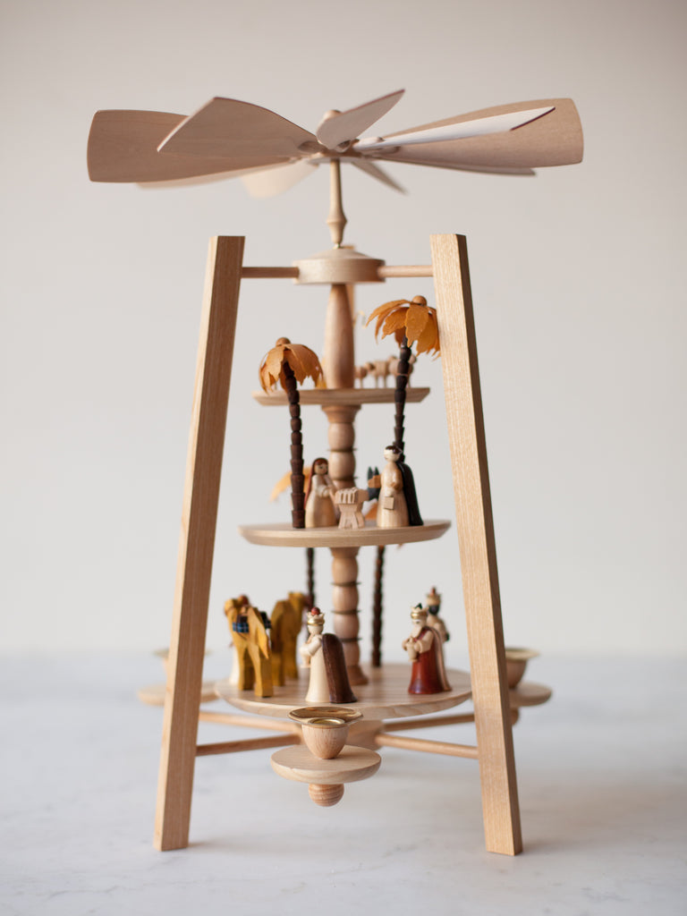 Front view of asymmetric nativity pyramid. The pyramid has three tiers: one tier of wise men, one tier of the Holy Family, and one tier of shepherds. 