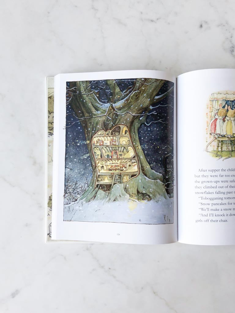 An open page of a book, with artwork of a dark winter night and a barren tree used as a bookshelf in the trunk.