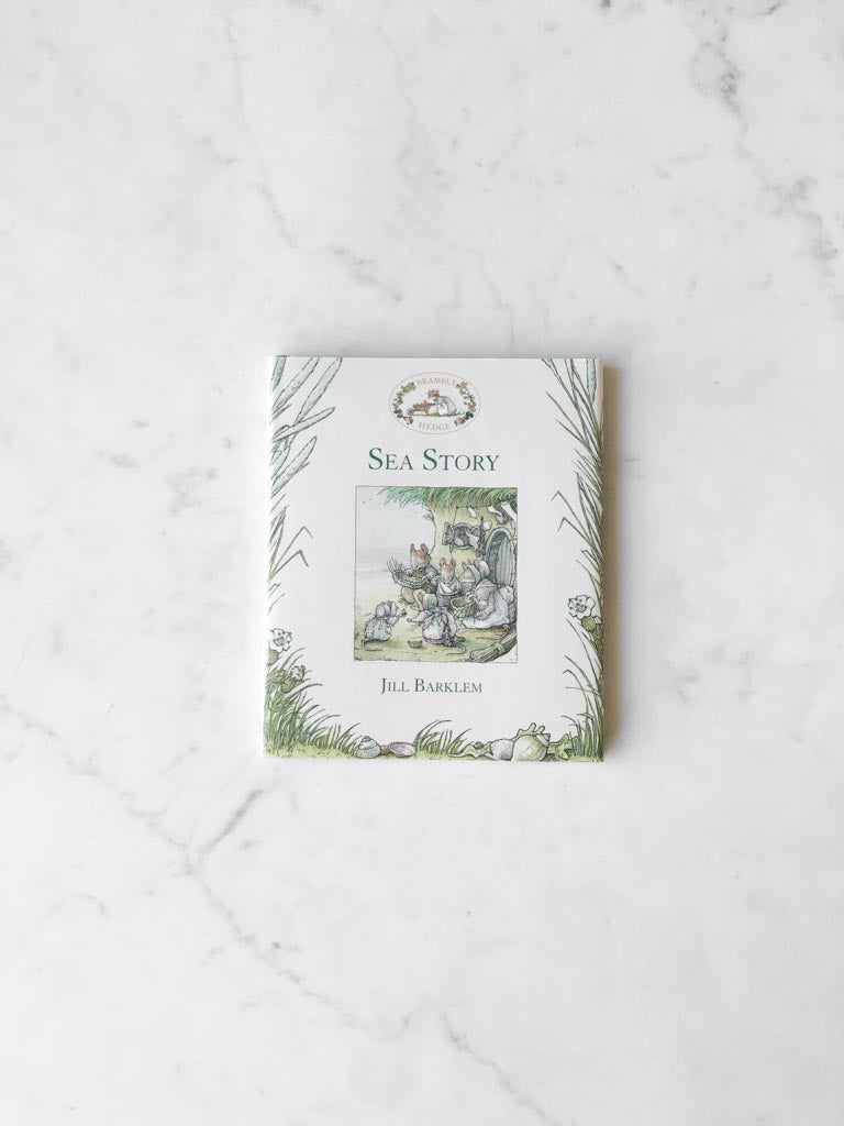 The cover of A Sea Story, with costal plants and a piece of character art work in the middle.