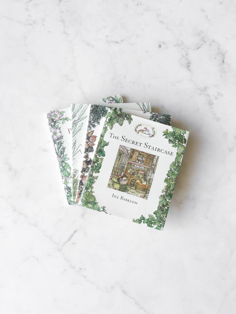 Four books with various plant details on their covers stacked on top of each other.