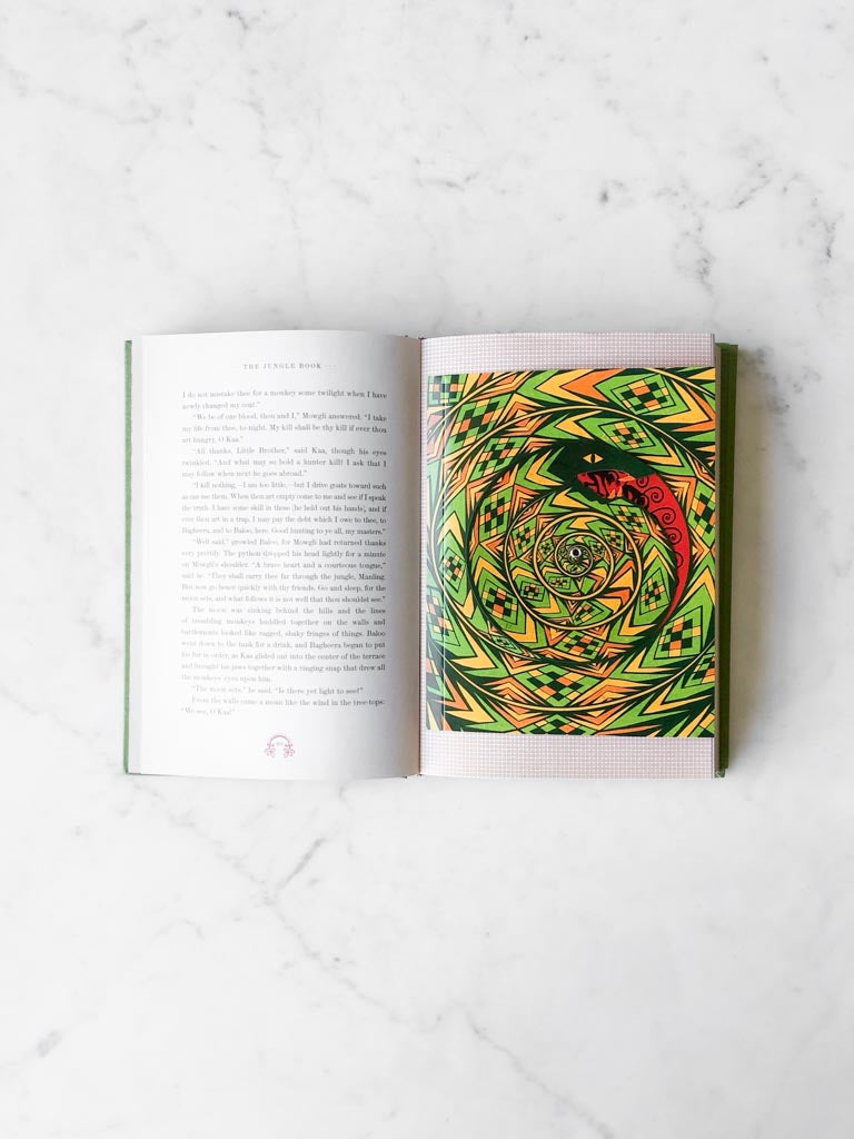 An open page from The Jungle Book with a large colorful and spiral drawing and the words of the story.