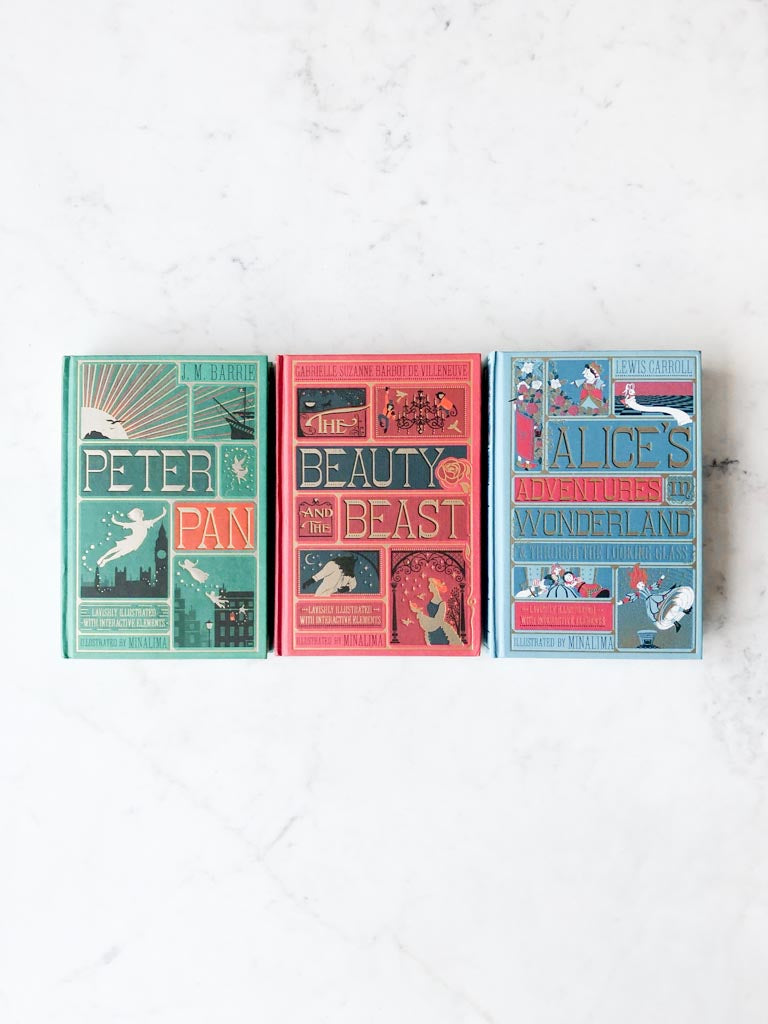The covers of Peter Pan, Beauty and the Beast, and Alice’s Adventures in Wonderland lined up in a row.