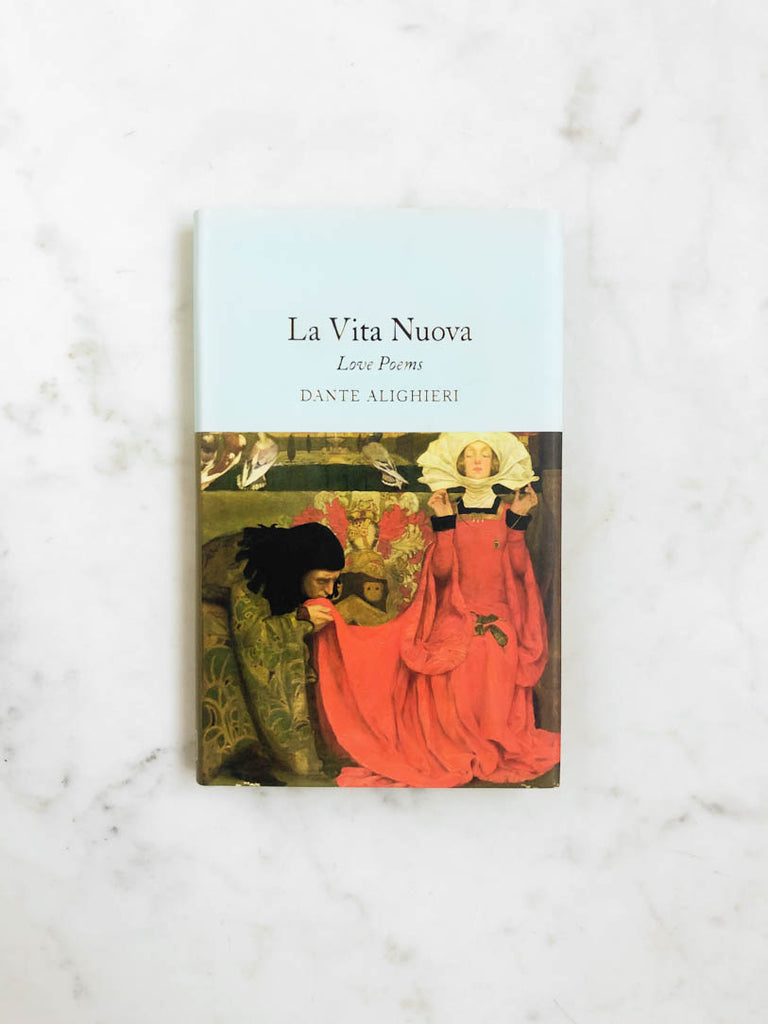A blue book with gold lettering titled “La Vita Nuova” with an illustration of a man kissing a woman’s dress on the cover. 